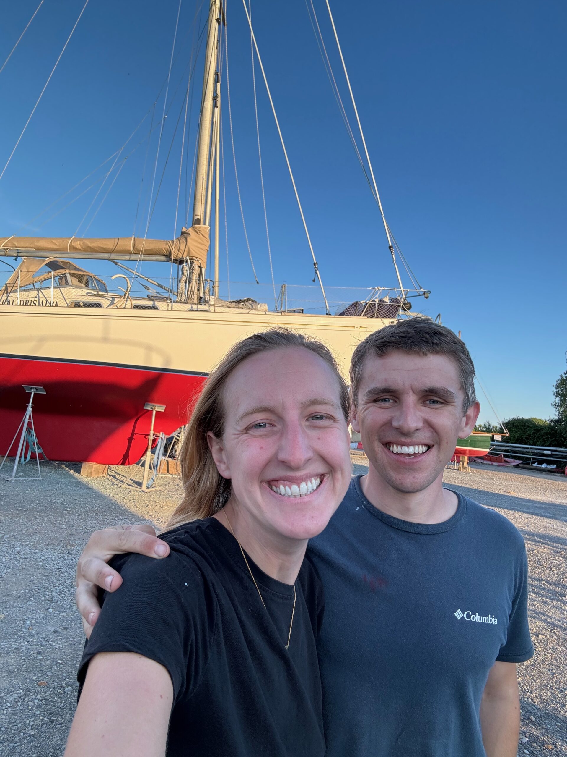 Fran and Jack standing in front of Calidris Alba after the boatyard work is done