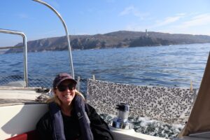 Fran sitting in front of the land - our first sight of mainland Spain