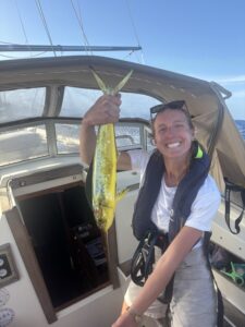 Fran holding a mahi mahi, the first fish caught on our Atlantic crossing